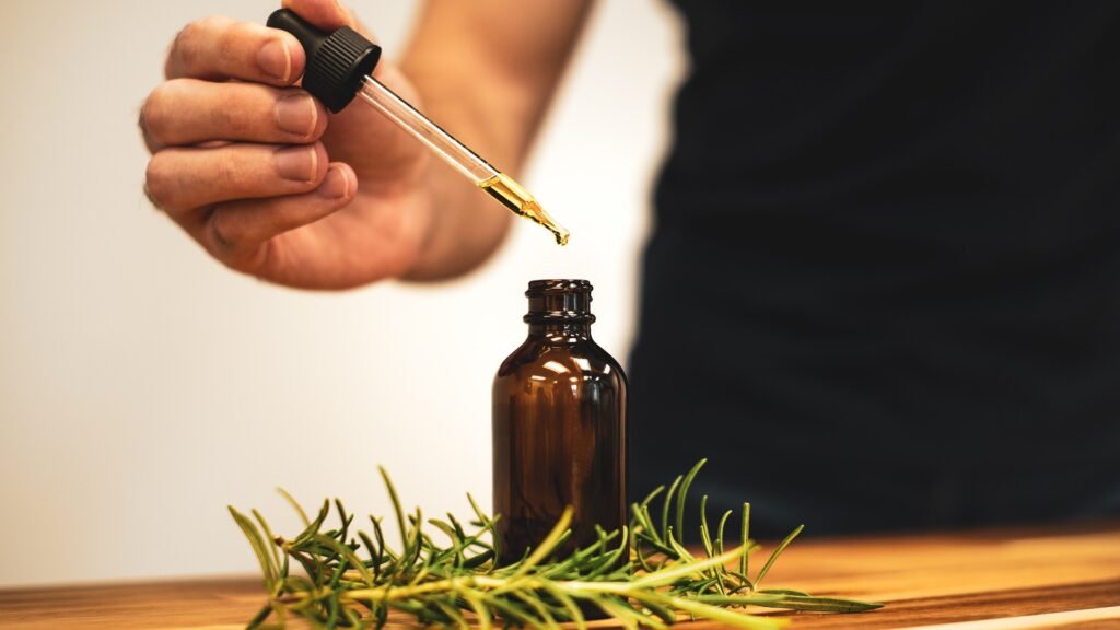 Amber dropper bottle applying pure botanical ginseng scalp serum for hair follicle density